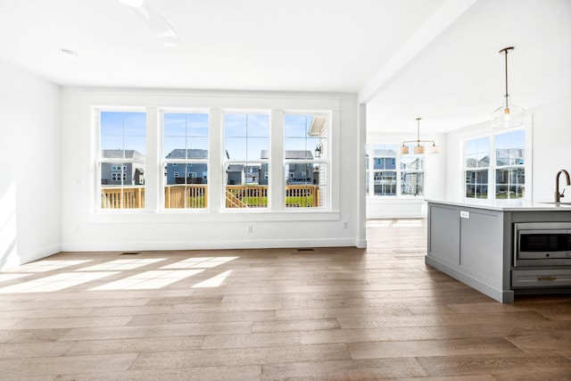 unfurnished sunroom with a sink