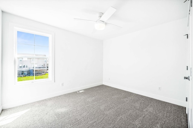 unfurnished room with baseboards, a ceiling fan, and carpet
