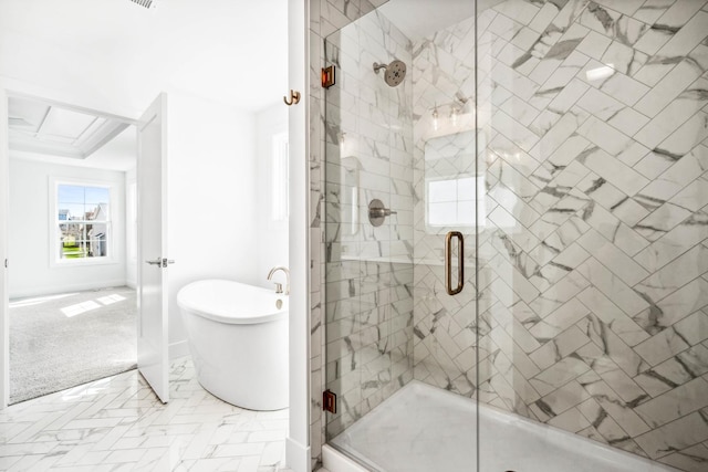 bathroom with a shower stall and a soaking tub