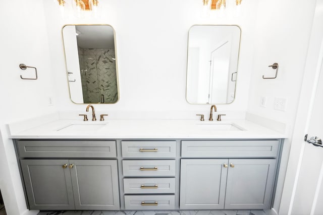 bathroom featuring a sink, double vanity, and marble finish floor
