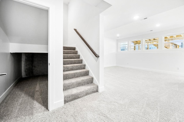 stairway featuring carpet floors, baseboards, recessed lighting, and visible vents