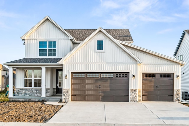 modern farmhouse style home featuring board and batten siding, a garage, stone siding, a shingled roof, and driveway