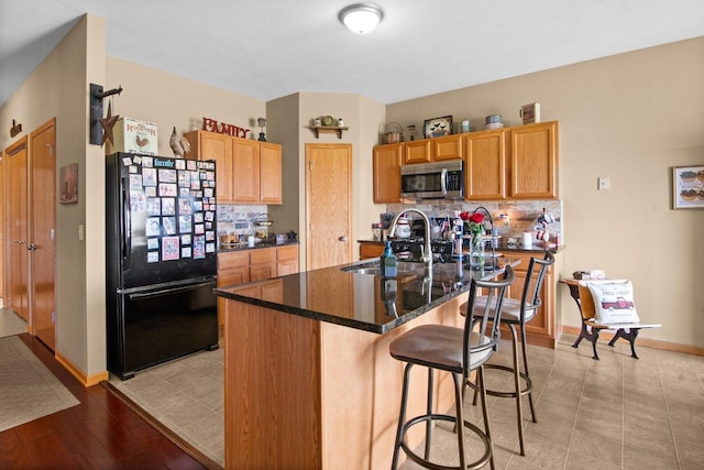 411 Anjali Ct, Sycamore, IL 60178 - kitchen with freestanding refrigerator, stainless steel microwave, backsplash, and a sink