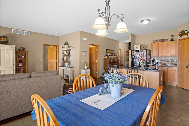 411 Anjali Ct, Sycamore, IL 60178 - dining space with a chandelier and dark tile patterned floors