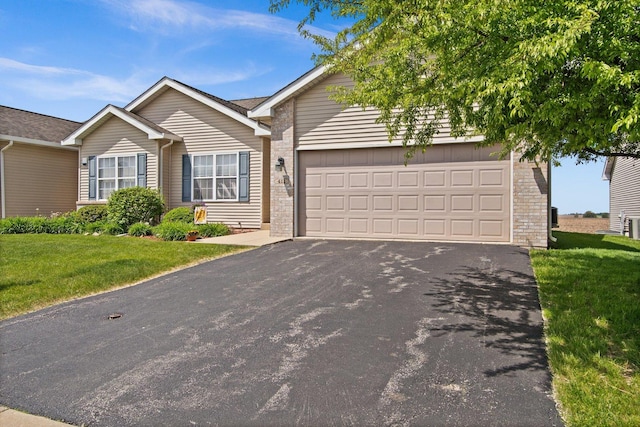 411 Anjali Ct, Sycamore, IL 60178 - ranch-style house with asphalt driveway, a front yard, stone siding, and an attached garage