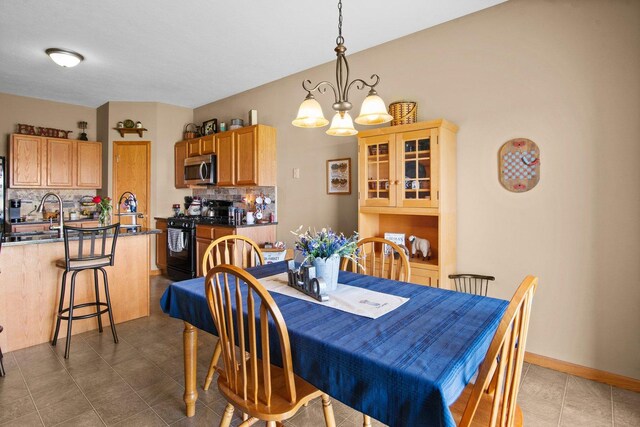 411 Anjali Ct, Sycamore, IL 60178 - dining space with light tile patterned floors and a chandelier