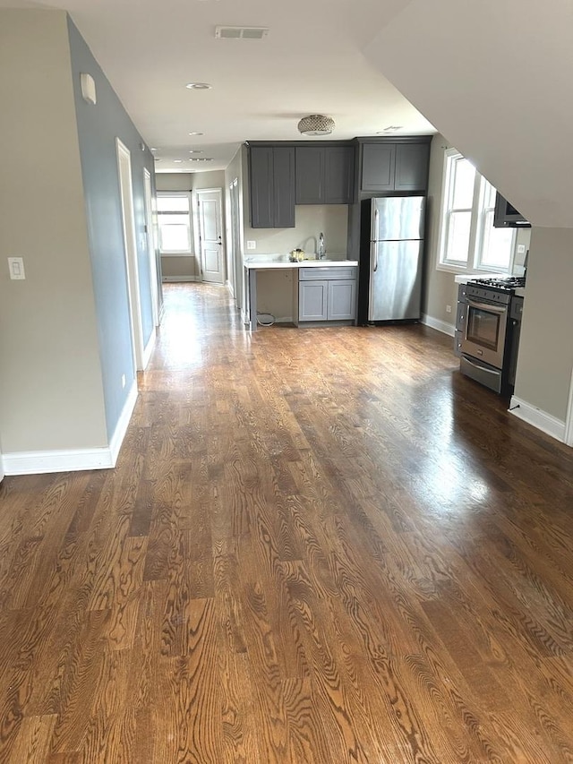 5810 W 64th Pl, Chicago, IL 60638 - unfurnished living room with dark wood-style flooring, baseboards, and a sink