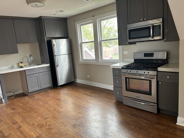 5810 W 64th Pl, Chicago, IL 60638 - kitchen featuring appliances with stainless steel finishes, gray cabinetry, light countertops, and baseboards