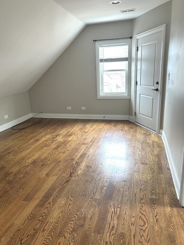 5810 W 64th Pl, Chicago, IL 60638 - additional living space with lofted ceiling, wood finished floors, and baseboards