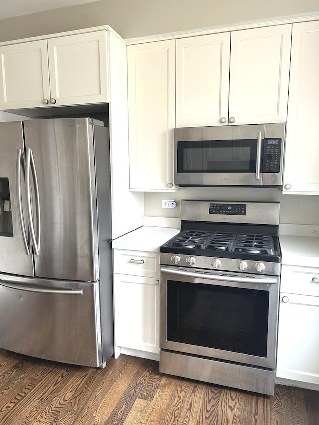 5810 W 64th Pl, Chicago, IL 60638 - kitchen with stainless steel appliances, dark wood-style flooring, light countertops, and white cabinets