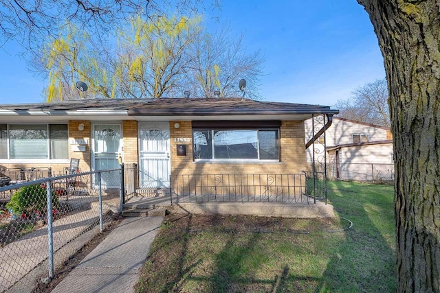 bungalow-style house with brick siding, a front lawn, and fence