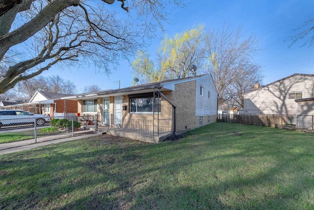 view of front of house featuring a front yard, brick siding, fence private yard, and crawl space