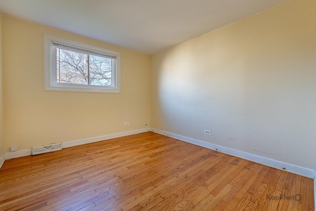 spare room with visible vents, baseboards, and light wood-style floors