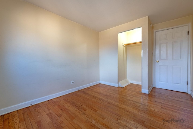 unfurnished bedroom with baseboards and light wood finished floors