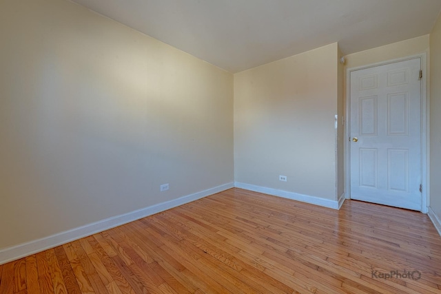 spare room with light wood finished floors and baseboards