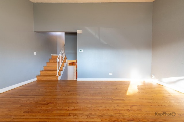 interior space with baseboards and wood finished floors