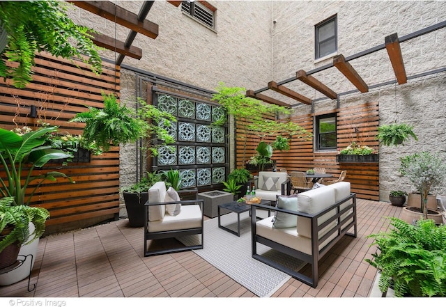 wooden deck with outdoor lounge area and a pergola