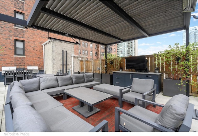 view of patio / terrace featuring an outdoor hangout area, fence, and grilling area