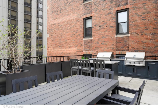 wooden deck with outdoor dining space and area for grilling