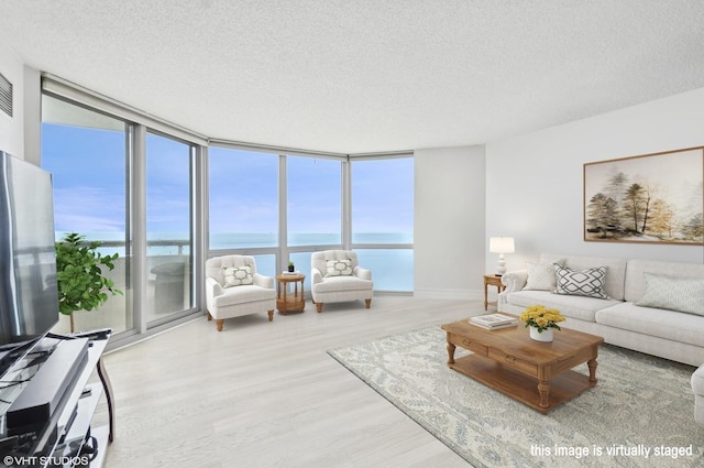 195 N Harbor Dr Unit 2602, Chicago, IL 60601 - living room with wood finished floors, baseboards, a textured ceiling, a water view, and expansive windows