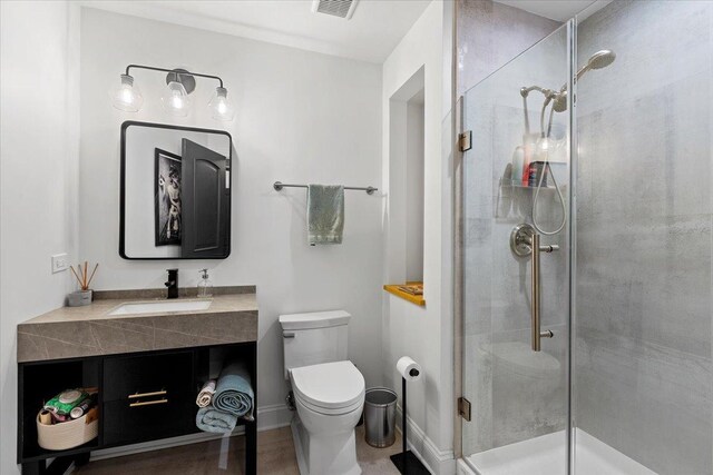 900 N Kingsbury St Unit 878, Chicago, IL 60610 - bathroom with a shower stall, toilet, vanity, and baseboards