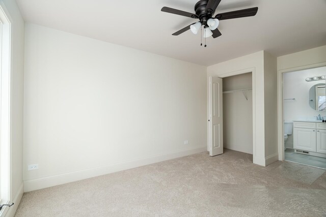 unfurnished bedroom featuring a closet, baseboards, ceiling fan, and light carpet