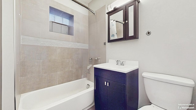 bathroom featuring toilet, vanity, and shower / bathtub combination