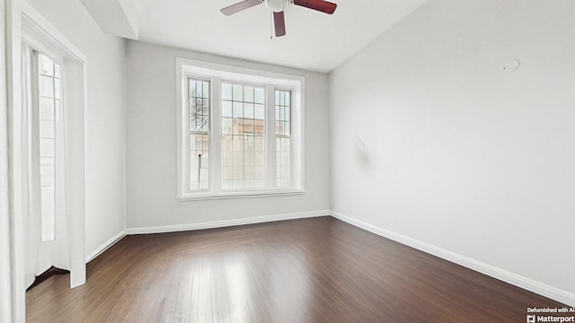 empty room with baseboards, wood finished floors, and ceiling fan