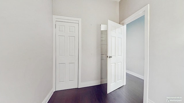 interior space featuring dark wood-style flooring and baseboards