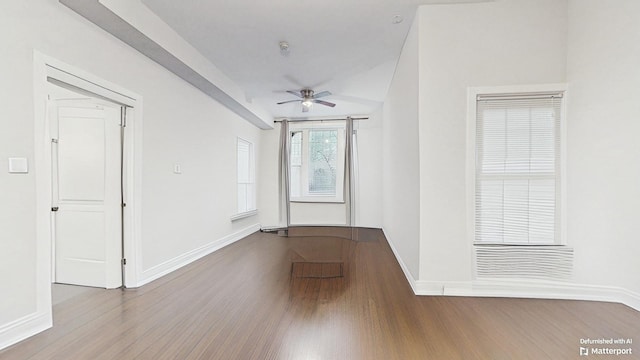 unfurnished room with wood finished floors, ceiling fan, and baseboards