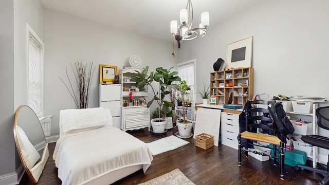 interior space featuring baseboards, freestanding refrigerator, an inviting chandelier, and wood finished floors