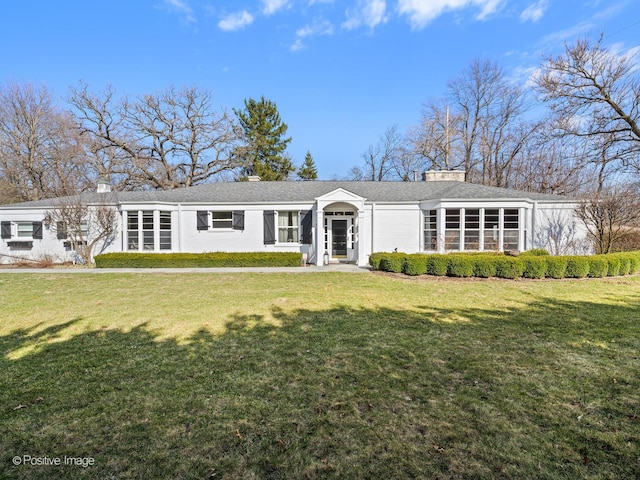 single story home featuring a front lawn and a chimney