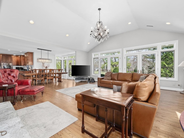 living room with an inviting chandelier, visible vents, recessed lighting, light wood-style flooring, and vaulted ceiling