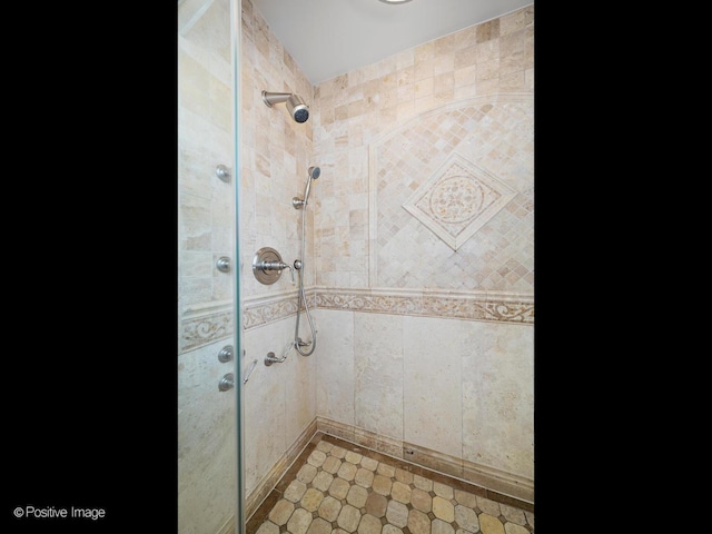 bathroom with a tile shower