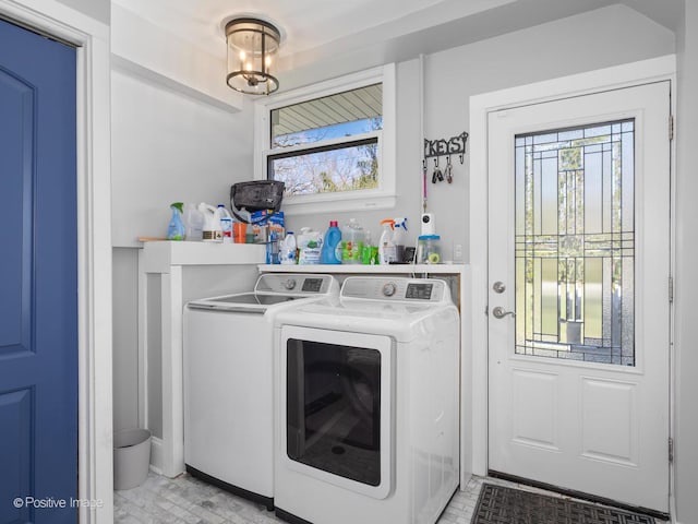washroom with separate washer and dryer and laundry area