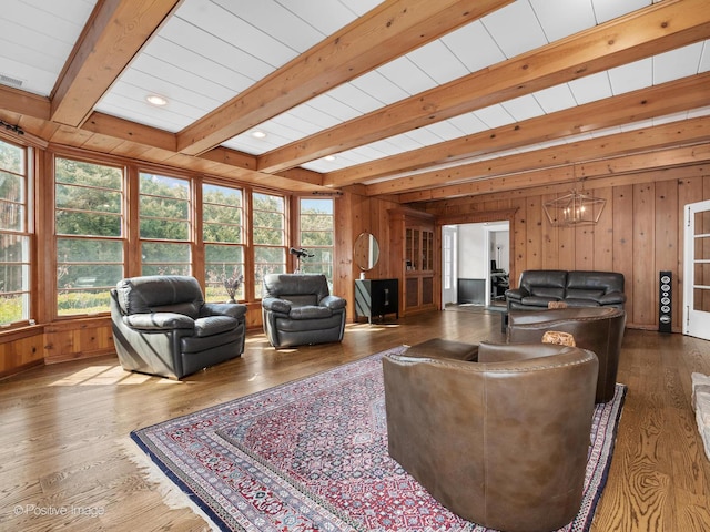 living room featuring hardwood / wood-style floors, plenty of natural light, wood walls, and beam ceiling