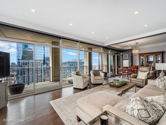 living area with floor to ceiling windows, crown molding, wood-type flooring, a notable chandelier, and recessed lighting