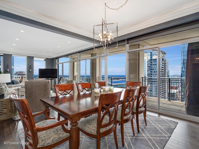 dining space featuring plenty of natural light, dark wood finished floors, expansive windows, and a notable chandelier