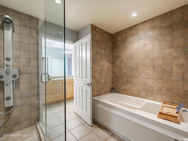 bathroom featuring tile patterned flooring, a garden tub, tile walls, recessed lighting, and a shower stall