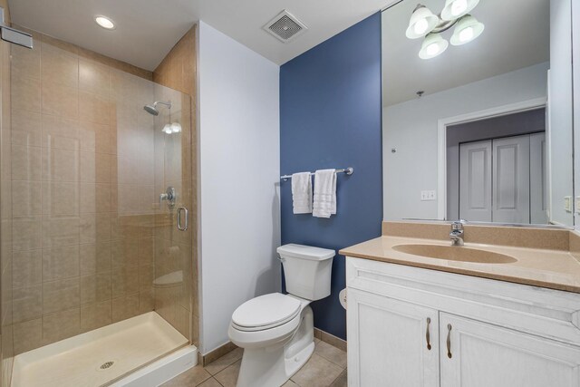 bathroom featuring visible vents, tile patterned flooring, a stall shower, vanity, and toilet