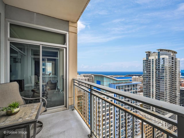 balcony featuring a view of city and a water view