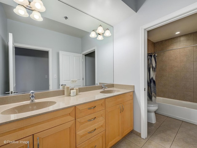 full bathroom with toilet, tile patterned floors, a chandelier, and a sink