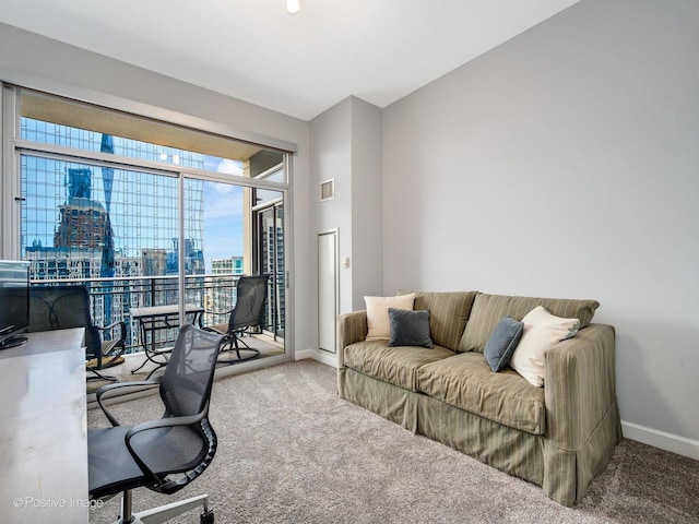 office area with carpet flooring, visible vents, and a wealth of natural light