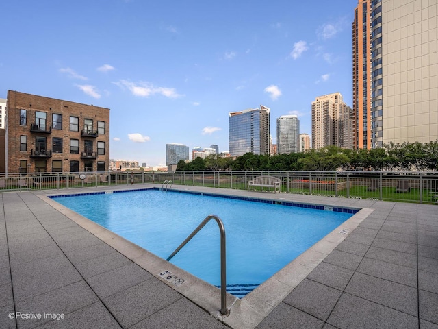 community pool featuring fence and a city view