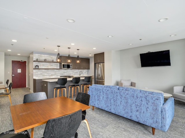 living room with recessed lighting and light carpet