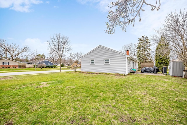 914 W Lynnwood Ave, Arlington Heights, IL 60004 - view of home's exterior featuring an outdoor structure, a chimney, a yard, and a shed