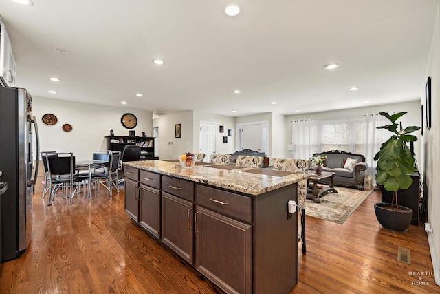 914 W Lynnwood Ave, Arlington Heights, IL 60004 - kitchen with a center island, freestanding refrigerator, dark wood-type flooring, and dark brown cabinets