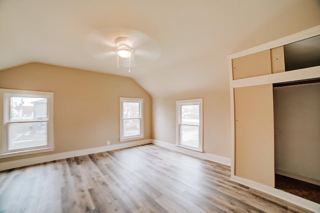 212 E Ash St, Watseka, IL 60970 - unfurnished bedroom featuring vaulted ceiling, wood finished floors, ceiling fan, and baseboards