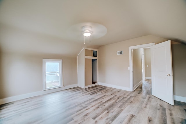 212 E Ash St, Watseka, IL 60970 - spare room featuring lofted ceiling, light wood finished floors, a ceiling fan, and baseboards