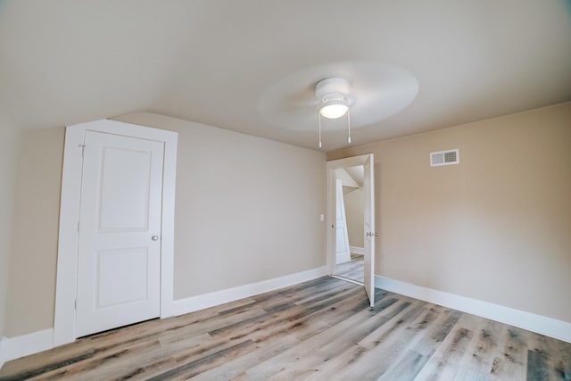 212 E Ash St, Watseka, IL 60970 - spare room featuring light wood-style floors, ceiling fan, lofted ceiling, and baseboards
